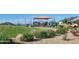 Community playground with play structures and shaded area at 18355 W Smoketree Dr, Wittmann, AZ 85361