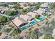 Aerial view of two homes with private pools, desert landscaping, and mountain views at 18605 N 90Th Way, Scottsdale, AZ 85255