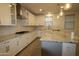 Modern kitchen with white cabinets and granite island at 18813 W Solano Dr, Litchfield Park, AZ 85340