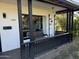 Covered porch with black railings, wicker bench, and window at 2045 W Orange Dr, Phoenix, AZ 85015