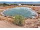 Aerial view of a property with a pond and fenced area at 27407 N 156Th St, Scottsdale, AZ 85262