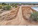 Aerial view of a property with a pond, a metal building, and a fenced area at 27407 N 156Th St, Scottsdale, AZ 85262