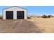 Two-door white shop with black doors on a desert property at 27407 N 156Th St, Scottsdale, AZ 85262