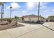 House with palm trees and a long driveway leading to the entrance at 3853 E June Cir, Mesa, AZ 85205