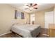 Bright bedroom with ceiling fan and bathroom access at 456 N 96Th Pl, Mesa, AZ 85207