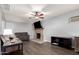 Cozy living room features a fireplace, hardwood floors, and ceiling fan at 456 N 96Th Pl, Mesa, AZ 85207