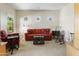 Cozy sitting room featuring a comfortable sofa, charming windows, and a rocking chair at 4719 W Silva Dr, New River, AZ 85087