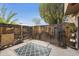 Private backyard with wooden fence, stone accents, and patio rug at 4901 E Kelton Ln # 1006, Scottsdale, AZ 85254