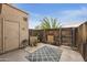 Private backyard with wooden fence, stone accents, and patio rug at 4901 E Kelton Ln # 1006, Scottsdale, AZ 85254
