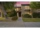 Two-story stucco home with a red tile roof, landscaping, and walkway at 4901 E Kelton Ln # 1006, Scottsdale, AZ 85254