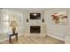 Corner fireplace with light colored tile and hardwood floors at 4901 E Kelton Ln # 1006, Scottsdale, AZ 85254