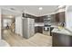 Galley kitchen with dark brown cabinets, stainless steel appliances, and granite counters at 4901 E Kelton Ln # 1006, Scottsdale, AZ 85254