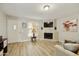 Living room with fireplace, hardwood floors and a view into the kitchen at 4901 E Kelton Ln # 1006, Scottsdale, AZ 85254