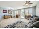 Living room with wood-look floors, sliding door to backyard, and comfy seating at 6027 N 132Nd Dr, Litchfield Park, AZ 85340