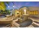 Evening view of a well-equipped outdoor kitchen and patio area at 6237 S Moccasin Trl, Gilbert, AZ 85298