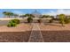 Landscaped backyard with a brick pathway and gazebo at 6523 N 135Th Dr, Glendale, AZ 85307