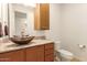 Bathroom with granite countertop, vessel sink, and updated toilet at 6523 N 135Th Dr, Glendale, AZ 85307