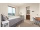 Bedroom with a double bed, a small desk and chair, and an ensuite bathroom at 6523 N 135Th Dr, Glendale, AZ 85307