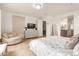 Bright bedroom with comfortable seating and en-suite bathroom access at 6523 N 135Th Dr, Glendale, AZ 85307