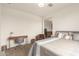 Spacious bedroom with a king-size bed, desk, and a view into a kitchenette at 6523 N 135Th Dr, Glendale, AZ 85307