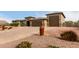 Front view of home with three car garage and brick driveway at 6523 N 135Th Dr, Glendale, AZ 85307