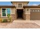 Inviting home exterior with brick accents and a two-car garage at 6523 N 135Th Dr, Glendale, AZ 85307