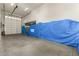 Large garage with an overhead door and storage at 6523 N 135Th Dr, Glendale, AZ 85307