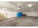 Large garage with overhead door and cabinet storage at 6523 N 135Th Dr, Glendale, AZ 85307