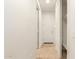Clean hallway with tile flooring, interior door, and closet at 6523 N 135Th Dr, Glendale, AZ 85307