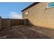 Large lot with a tan colored house, double gate, and a gravel driveway at 6523 N 135Th Dr, Glendale, AZ 85307