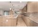 Long kitchen with granite countertops and stainless steel appliances at 6523 N 135Th Dr, Glendale, AZ 85307
