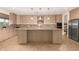 Large kitchen island with granite countertops and stainless steel appliances at 6523 N 135Th Dr, Glendale, AZ 85307
