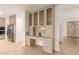 Built-in desk and glass-front cabinets offer extra storage in this kitchen at 6523 N 135Th Dr, Glendale, AZ 85307