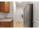 Laundry room with washer, dryer, and extra refrigerator at 6523 N 135Th Dr, Glendale, AZ 85307