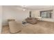 Comfortable living room featuring a sofa, chairs, and a grand piano at 6523 N 135Th Dr, Glendale, AZ 85307