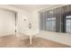 Bright room with a white baby grand piano and window at 6523 N 135Th Dr, Glendale, AZ 85307