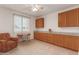 Home office with built-in cabinetry, desk, and comfortable seating at 6523 N 135Th Dr, Glendale, AZ 85307