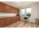 Bright office space with wood cabinets, granite countertop, and a view from the window at 6523 N 135Th Dr, Glendale, AZ 85307