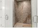 Large walk-in shower with multiple shower heads and marble tile at 6523 N 135Th Dr, Glendale, AZ 85307