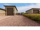 Side yard view of home with additional garage and gate at 6523 N 135Th Dr, Glendale, AZ 85307