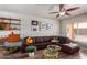 Spacious living room featuring a leather sectional sofa and mid-century modern decor at 714 W Fogal Way, Tempe, AZ 85282