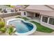 Inviting kidney-shaped pool with spacious patio and built-in BBQ at 7591 N 87Th Ave, Glendale, AZ 85305