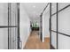 Bright hallway with glass barn doors leading to different rooms at 8302 N 86Th St, Scottsdale, AZ 85258