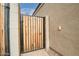 Backyard access with a wood and metal gate at 8522 W Georgetown Way, Florence, AZ 85132