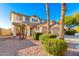 Two-story house with tan exterior, two-car garage, and desert landscaping at 8601 W Chickasaw St, Tolleson, AZ 85353