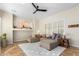 Living area with sectional sofa, ceiling fan and built-in shelving at 8601 W Chickasaw St, Tolleson, AZ 85353