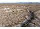 Aerial view showing home's location in a quiet desert neighborhood with mountain views at 1065 Buckboard Trl, Wickenburg, AZ 85390