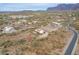 Aerial view of a house, showcasing its desert location and surroundings at 10751 E Cactus View Cir, Gold Canyon, AZ 85118