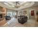 Spacious living room with high ceilings, fireplace, and leather furniture at 10751 E Cactus View Cir, Gold Canyon, AZ 85118