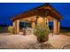 Covered outdoor kitchen with built-in grill and seating at 10751 E Cactus View Cir, Gold Canyon, AZ 85118